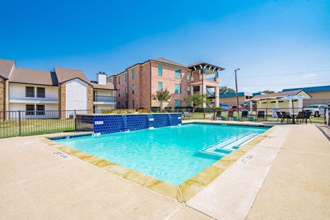 Harper Apartments in Dallas, Texas Pool with Lounge Chairs and Water Feature